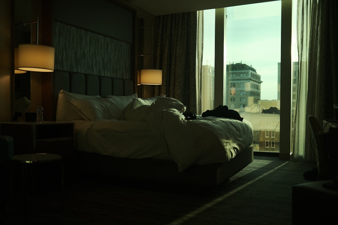 a-bedroom-with-a-large-bed-and-a-large-window-n4eg3hrszie
